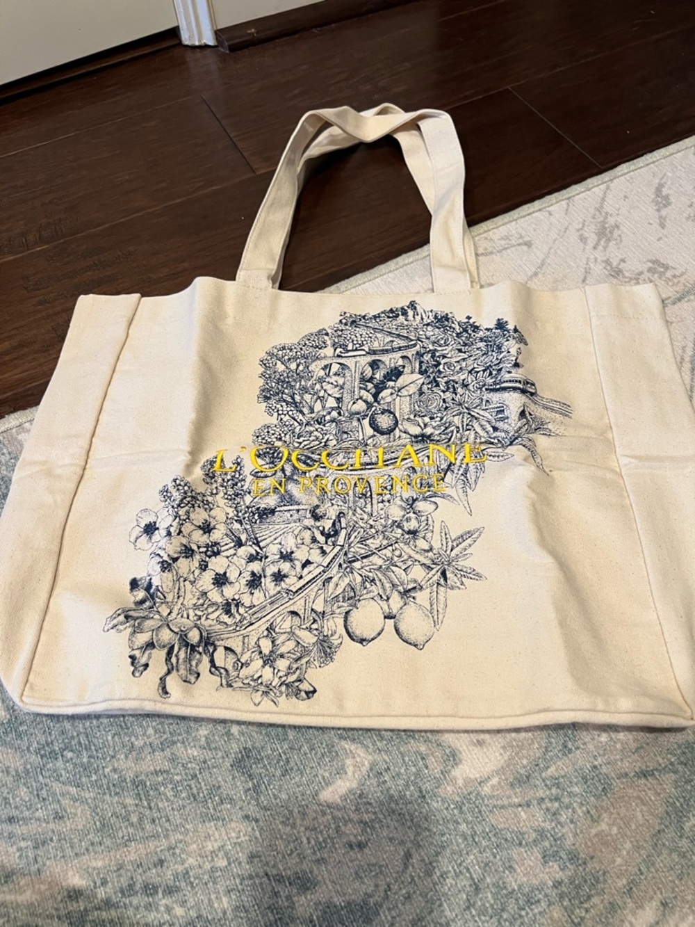 L'OCCITANE Cream Canvas Tote with Blue Botanical Print and Yellow Logo
